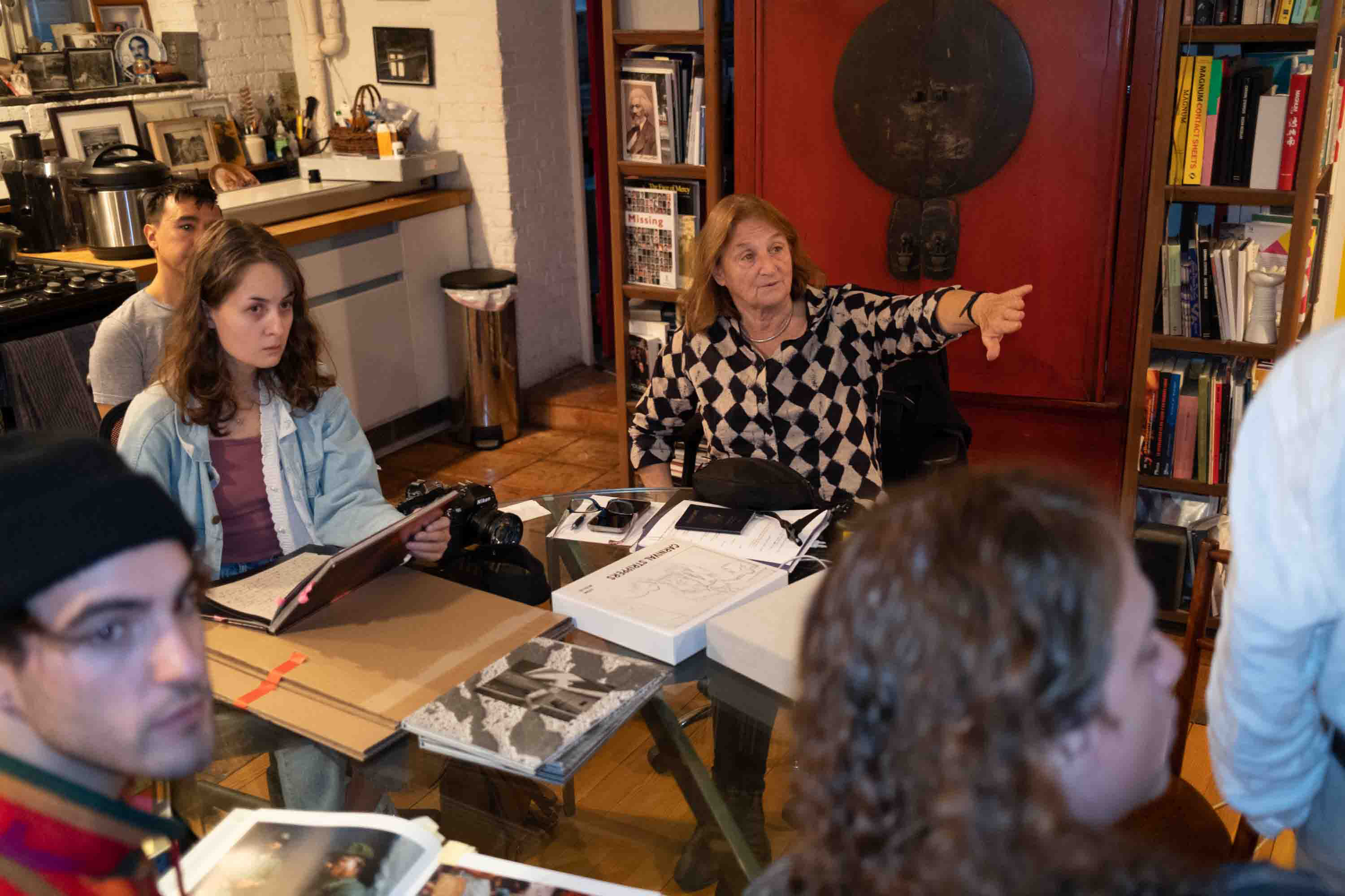 Legendary photojournalist Susan Meiselas speaks with a group of RIT photography students in her home.