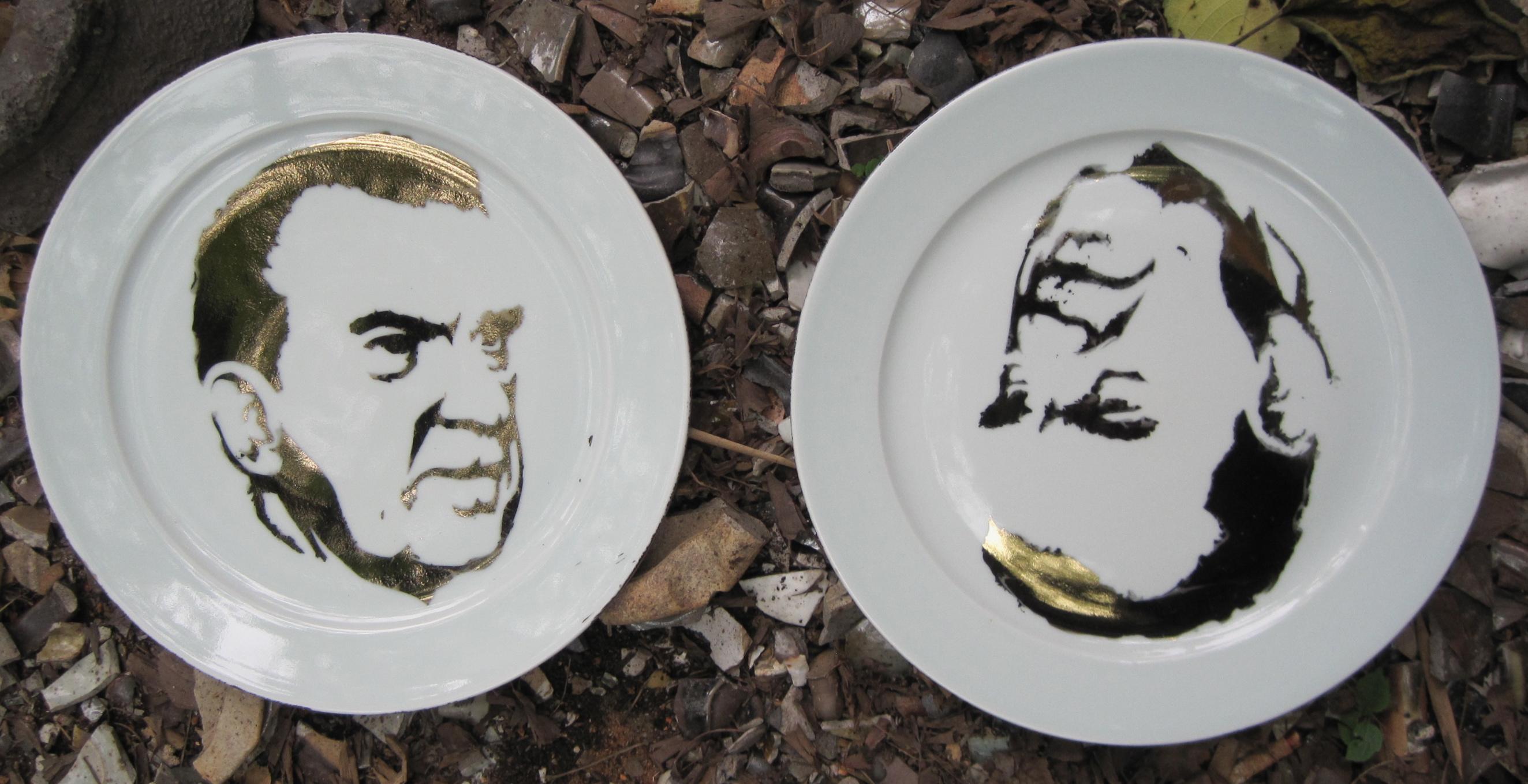 Two white plates with a drawing of a man.