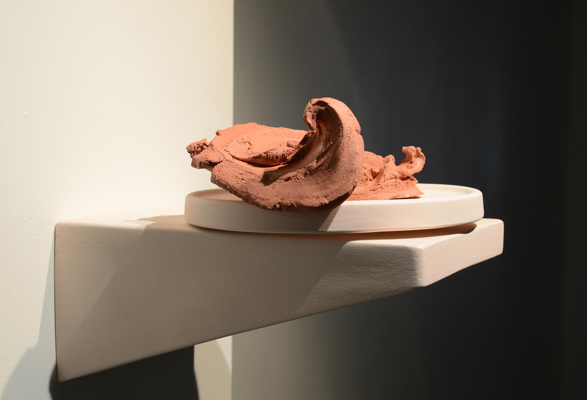 A ceramics project sits on a wall display.