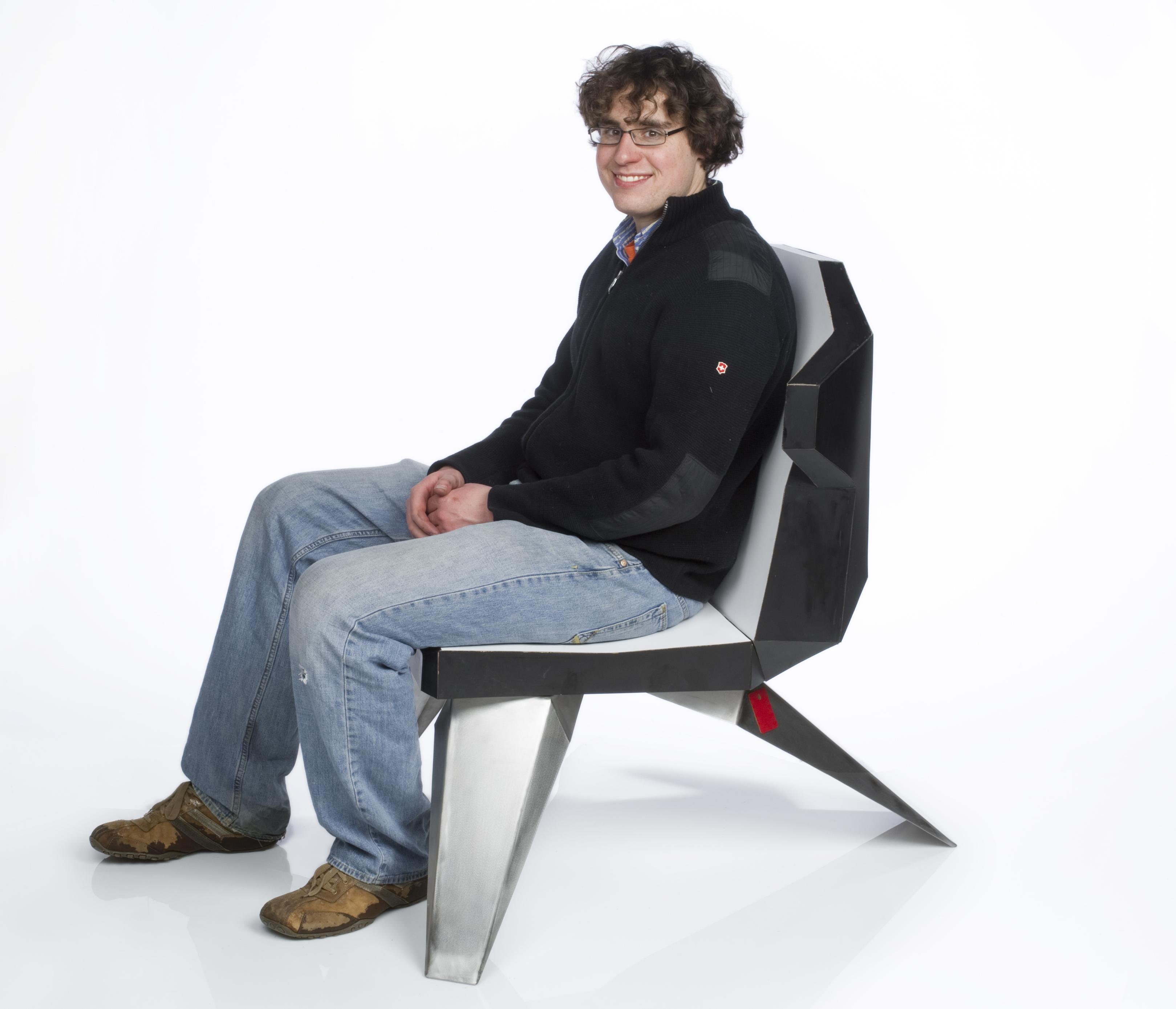 A person sits on a foldable chair.