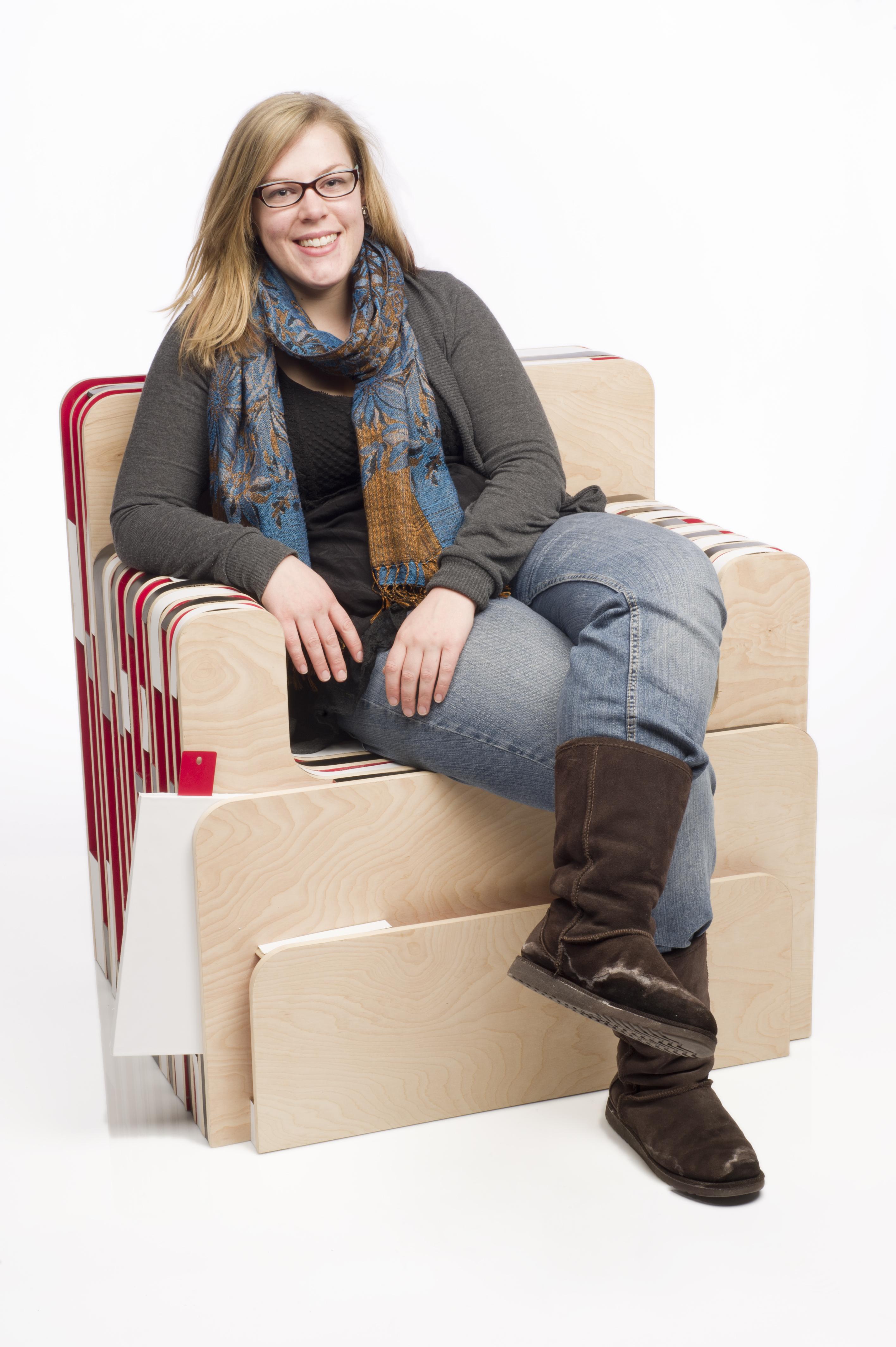 A person uses a wooden chair design mixed with different fabrics.