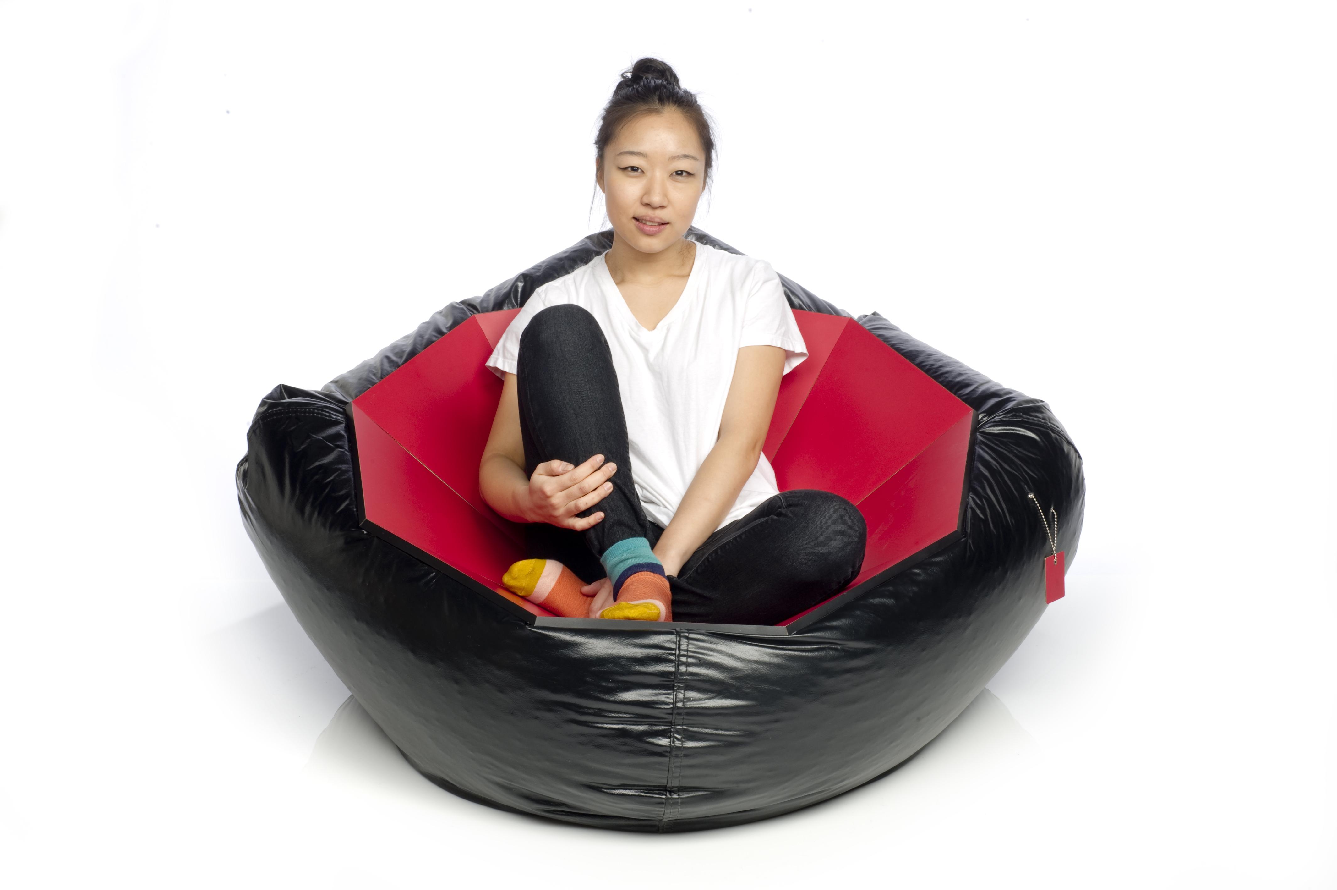 A person sits on a beanbag chair.