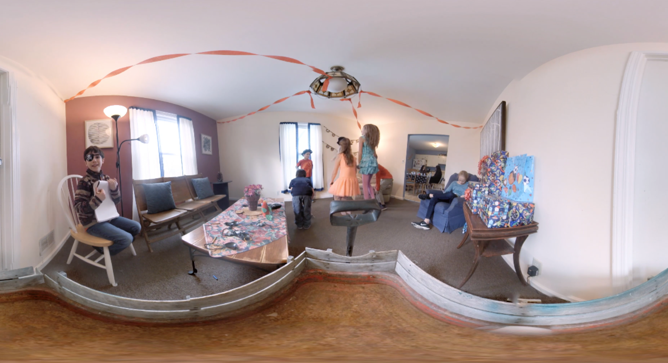 A panoramic photo of a room with children playing.