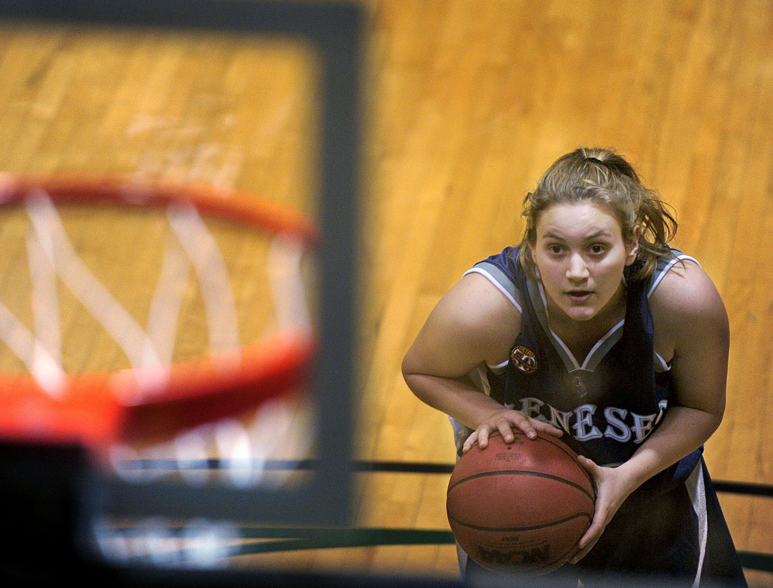 A girl shoots a free throw.