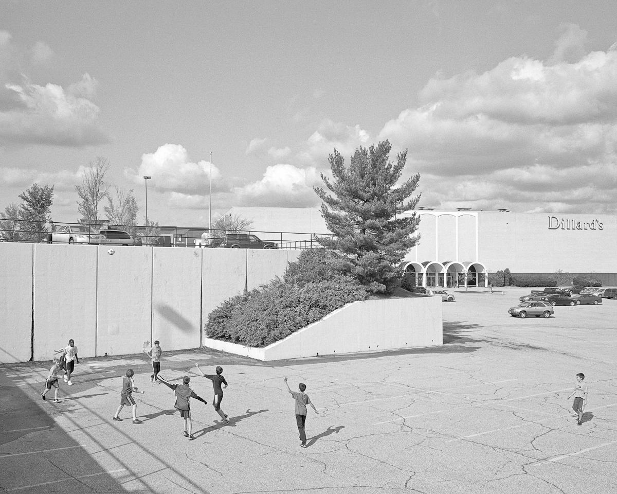 A black and white photo of people playing outside.