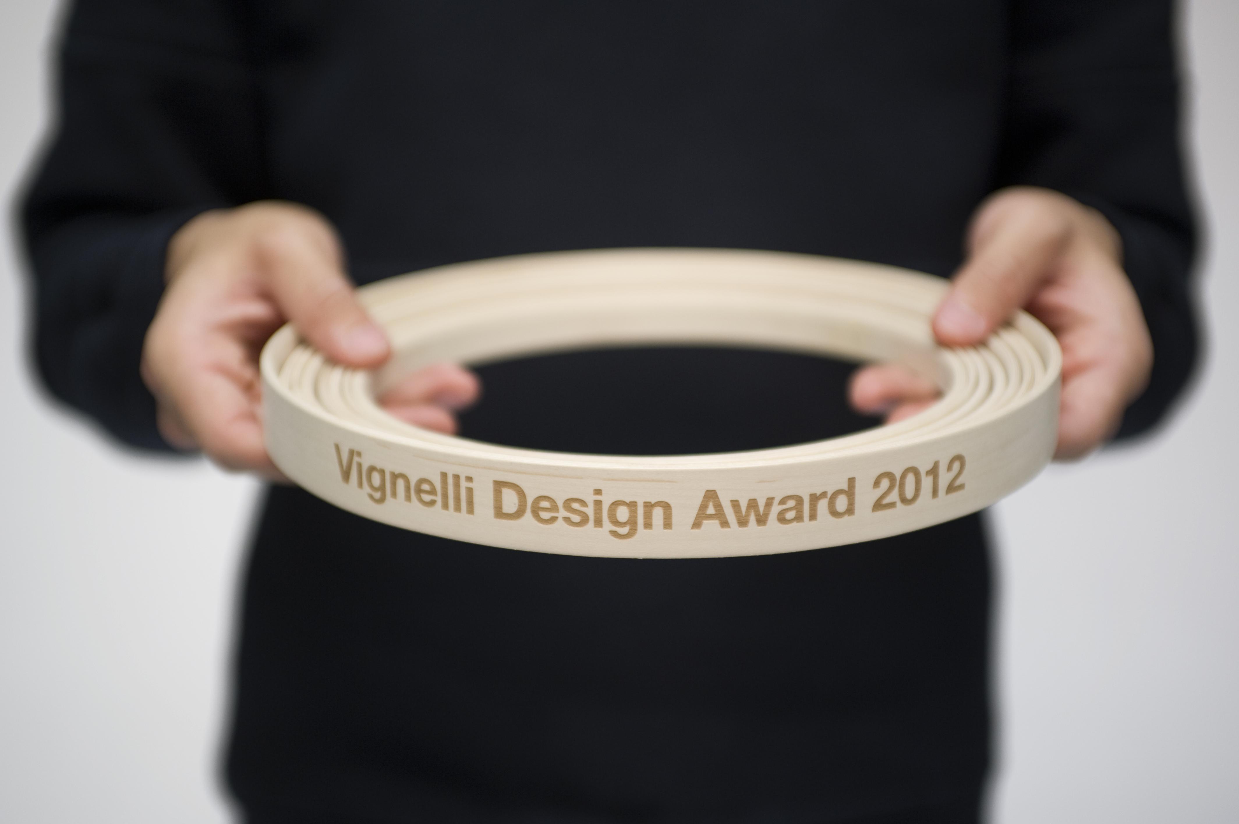 A circular band with Vignelli Design Award 2012 inscribed on it.