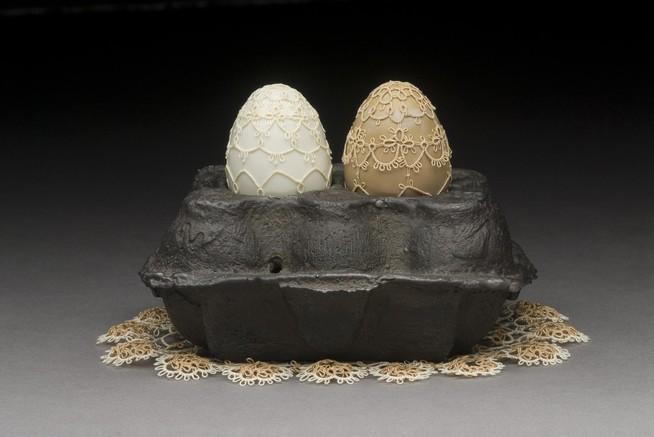 Two hot-worked glass eggs.