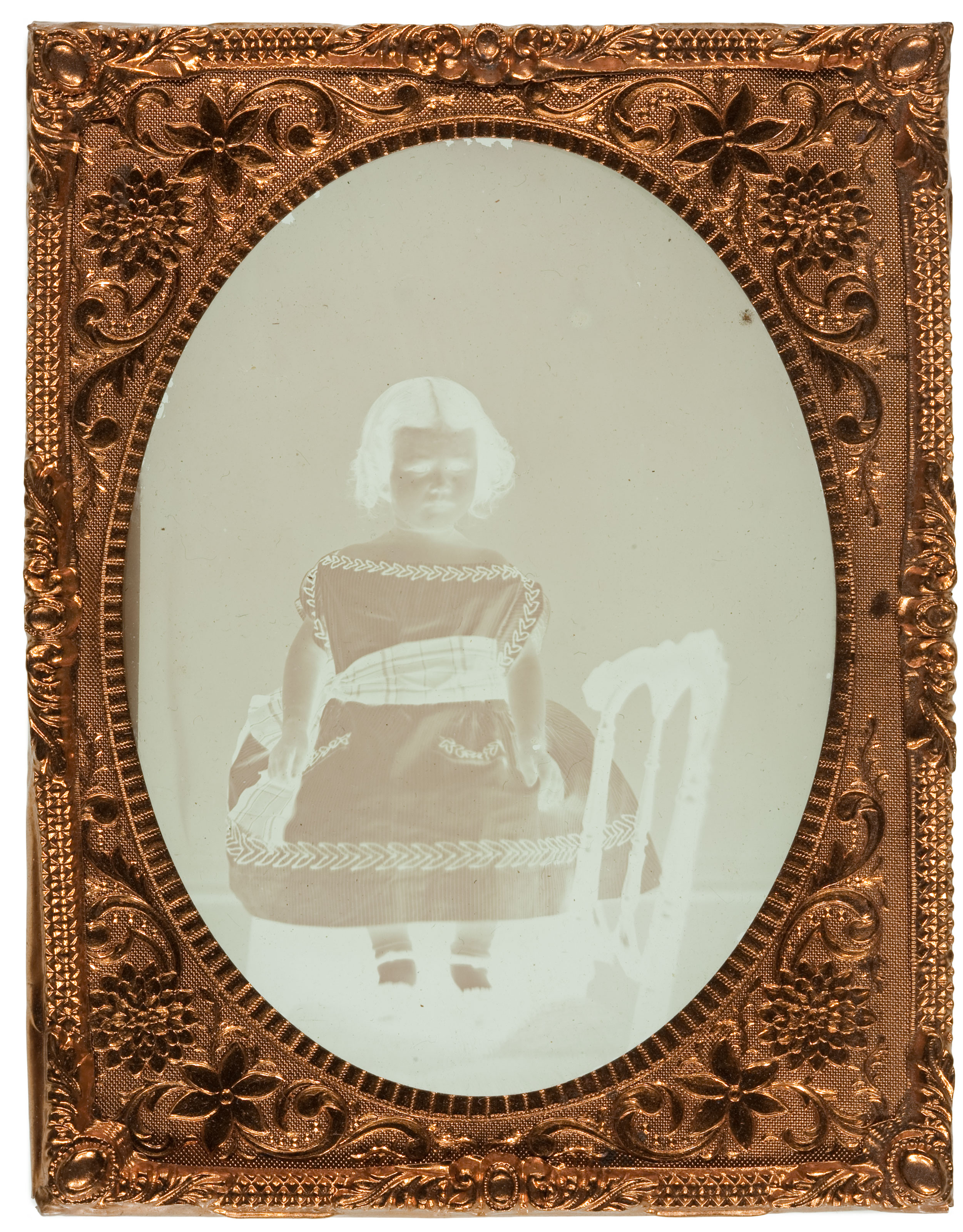 Some ambrotypes have a clear glass support. This object has been removed from its case and is without a black backing. Notice the image appears as a negative without the dark backing. 